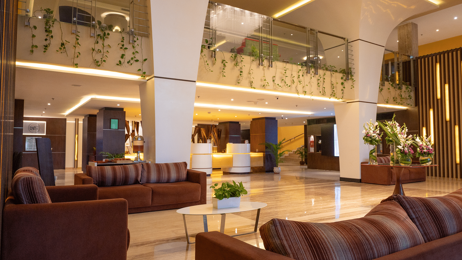 An image of lobby illuminating yellow lights at Grand Kakinada by GRT Hotels