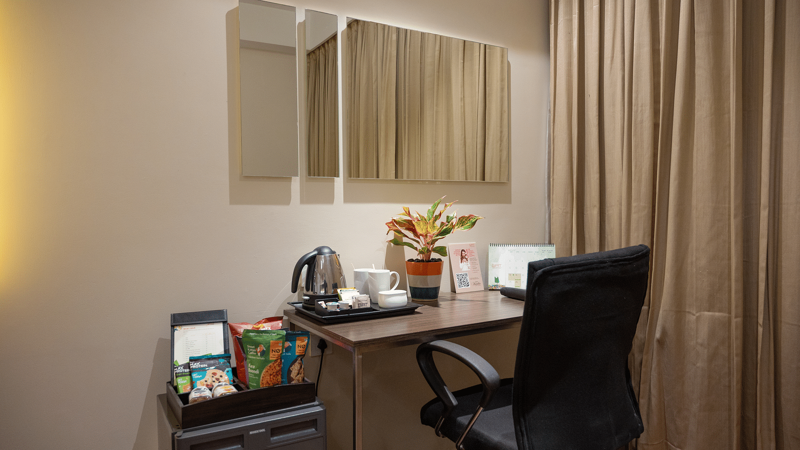 An image of writing table and a chair at Grand Kakinada by GRT Hotels