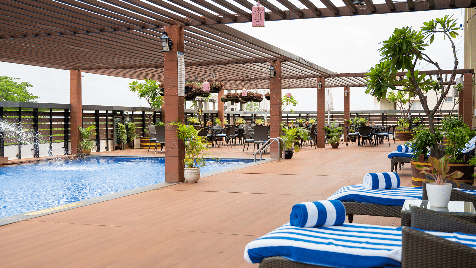 Image of sun loungers beside the pool at Grand Kakinada by GRT Hotels