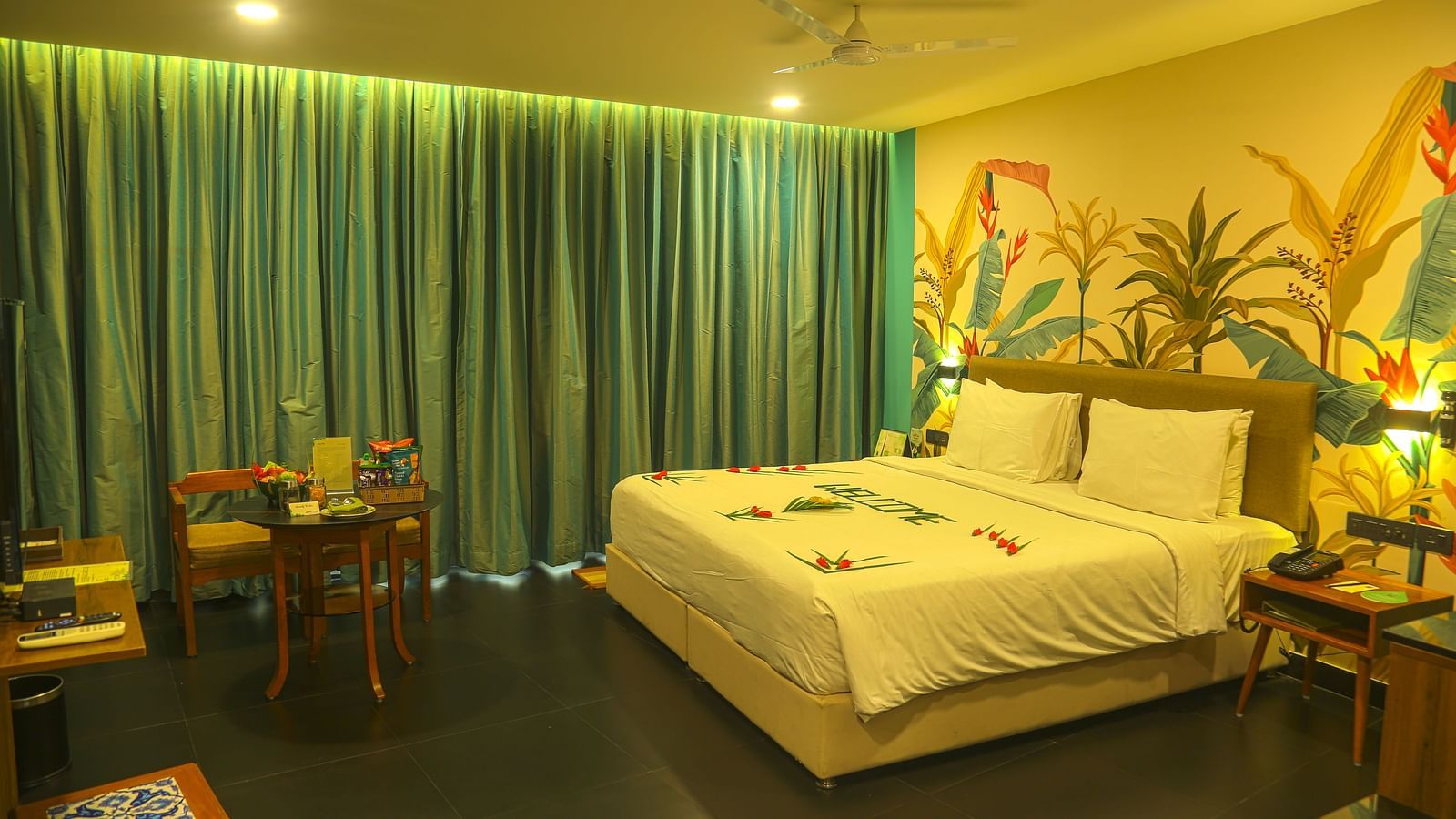 An image of a a valley view room with king size bed, bed side table, wardrobe, air-conditioner, and decorative items - Great Trails Yercaud by GRT Hotels