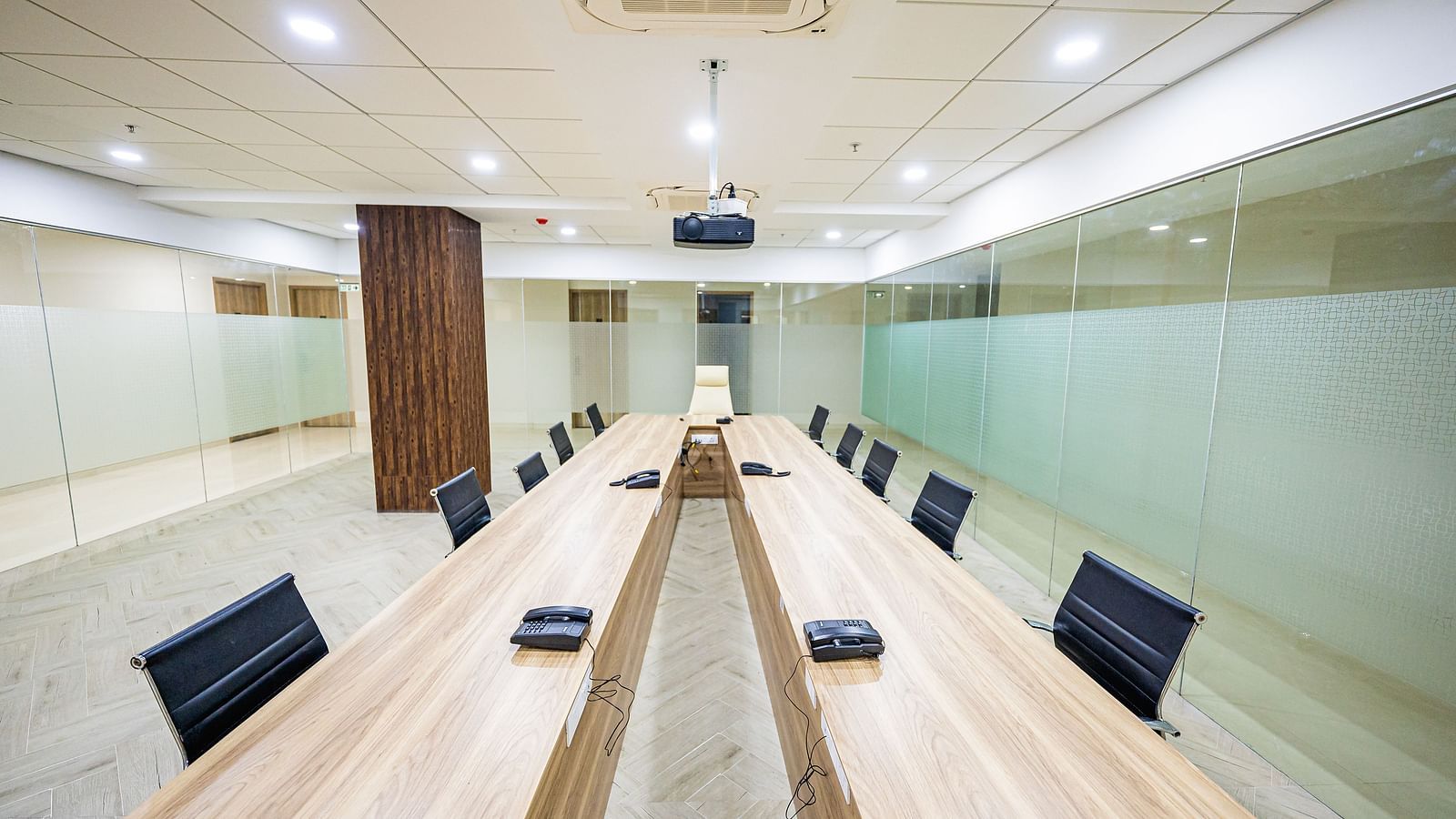 A spacious meeting room featuring a long wooden table and comfortable chairs at Lotus Leaf Boutique Hotel.