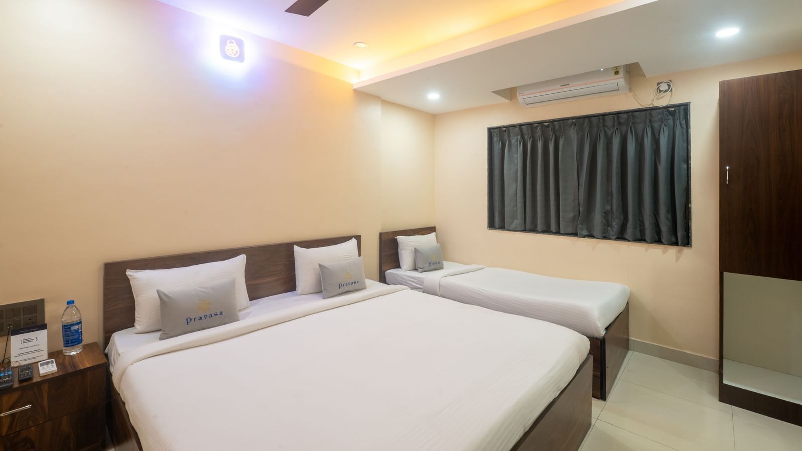 A room at Pravasa Stay, Shirdi, is a triple occupancy space with a double bed and a single bed.