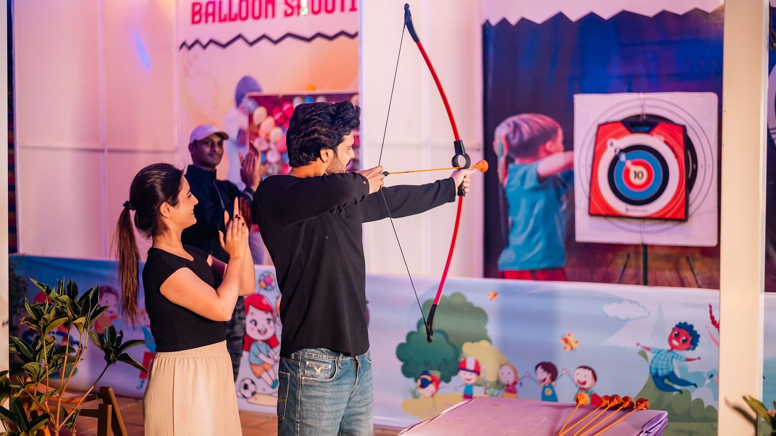 Family taking part in an archery session, a fun activity at The Grand Legacy Resort and Spa.