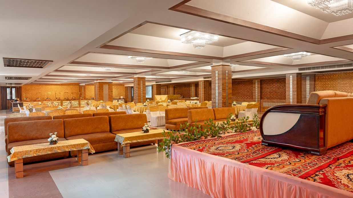 An elegant banquet hall featuring plush seating arrangements, designed for events and celebrations - Clarks Inn Express, Near Jammu Bari Brahmana Railway Station