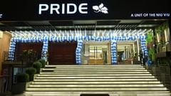 Hotel entrance lit with decorative lights and stairs leading to the lobby at Pride Elite Raipur.
