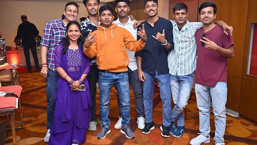 A group of people posing for a picture inside a hall