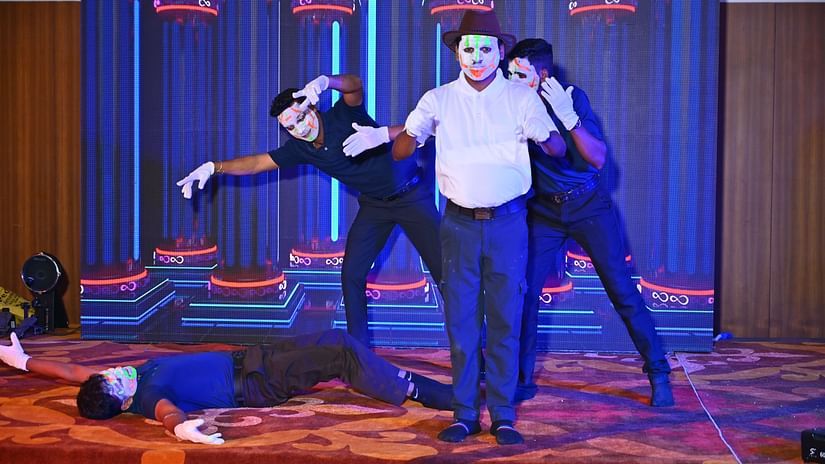 A picture featuring four people dancing with the masks on