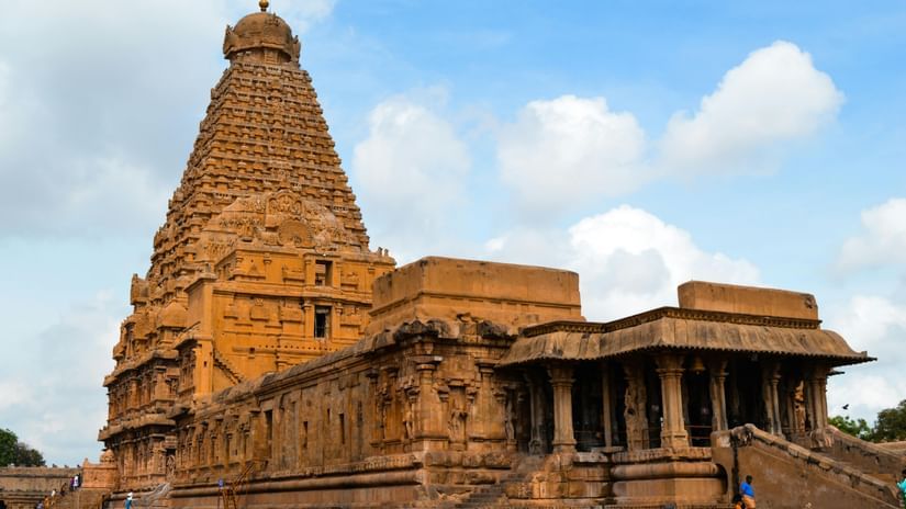 The Brihadeewarar temple exterior, seen with a bright sky in the background.