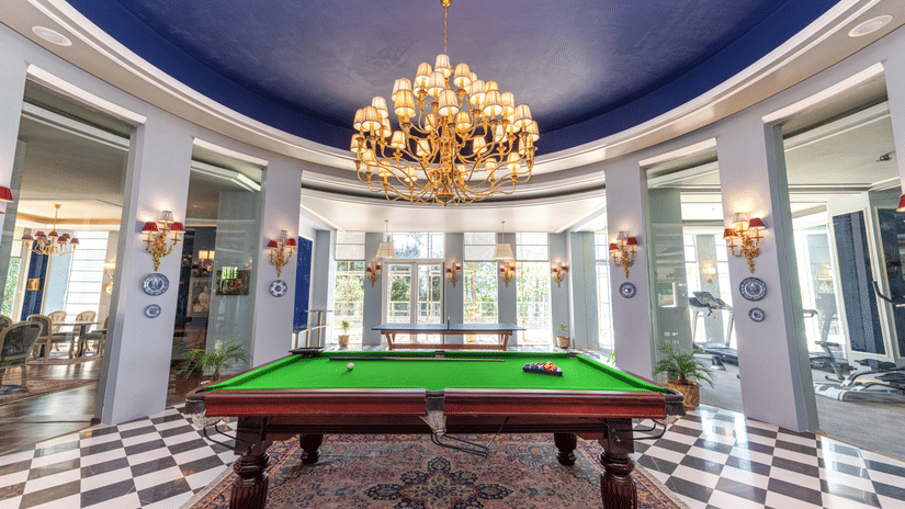 Another view of a chandelier hanging on top of a pool table placed on a carpet - The Manor Luxury Hotel, Shimla