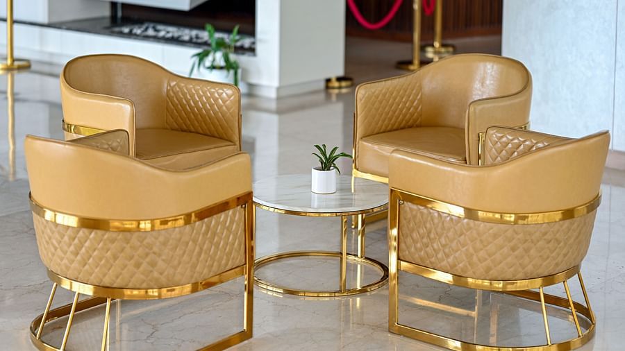 golden coloured sofa seats at the lobby area