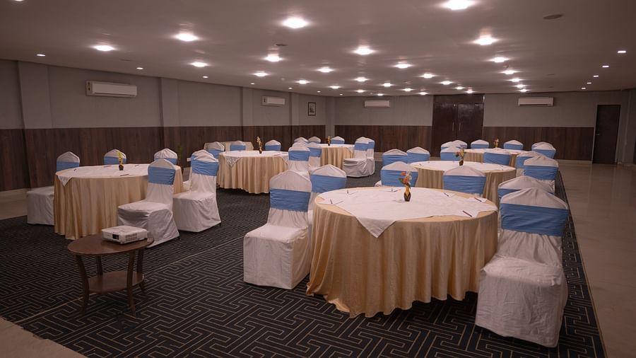 Banquet hall with round tables set up for an event at Clarks Collection Bhavnagar.