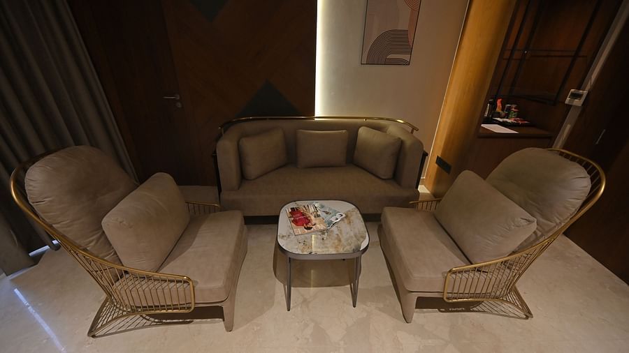 A close-up of a living area at Clarks Collection Grand Sapphire, Ajmer, featuring chairs with pillows and a table.
