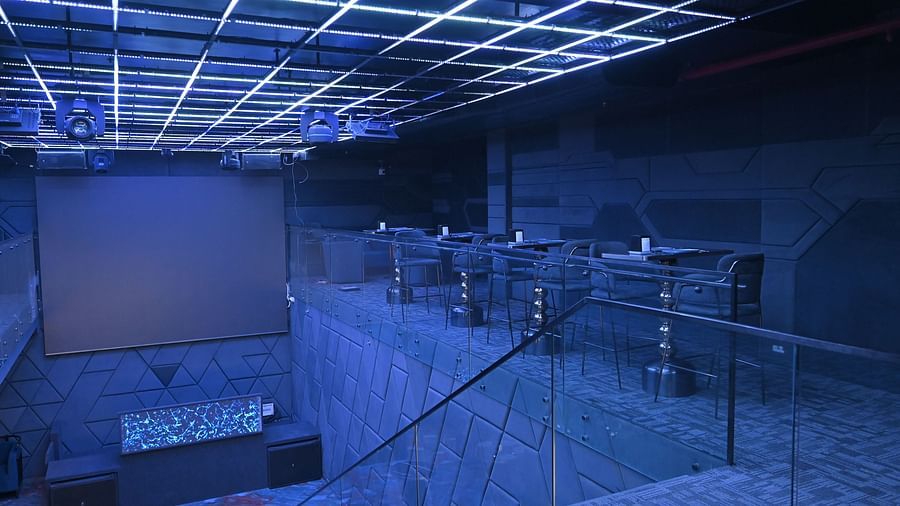A bar with a staircase illuminated by lights at Clarks Collection Grand Sapphire, Ajmer.
