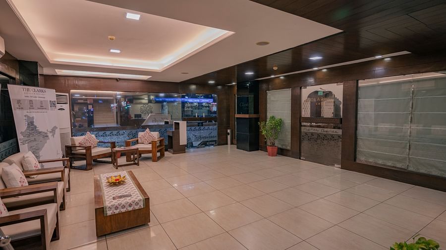 The lobby area with sofas and tiled flooring near the entrance of Clarks Collection, Vadodara.