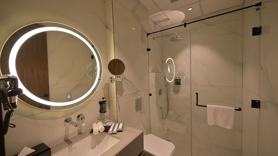 Vanity area of Deluxe Room with ambient lightning. - Clarks Safari Haridwar