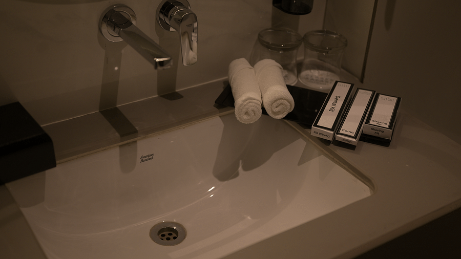 A bathroom sink with toiletries in Deluxe Room. - Clarks Safari Haridwar