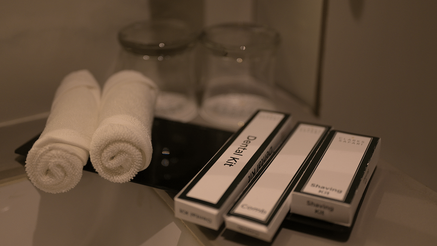 Hotel toiletries neatly arranged on a shelf in Deluxe Room. - Clarks Safari Haridwar