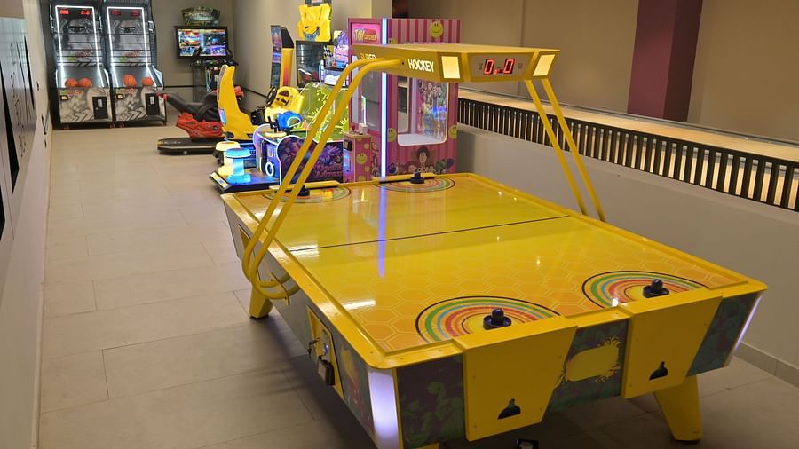 A bright contrast air hockey table along with other arcade machines in the room - Clarks Safari, Haridwar