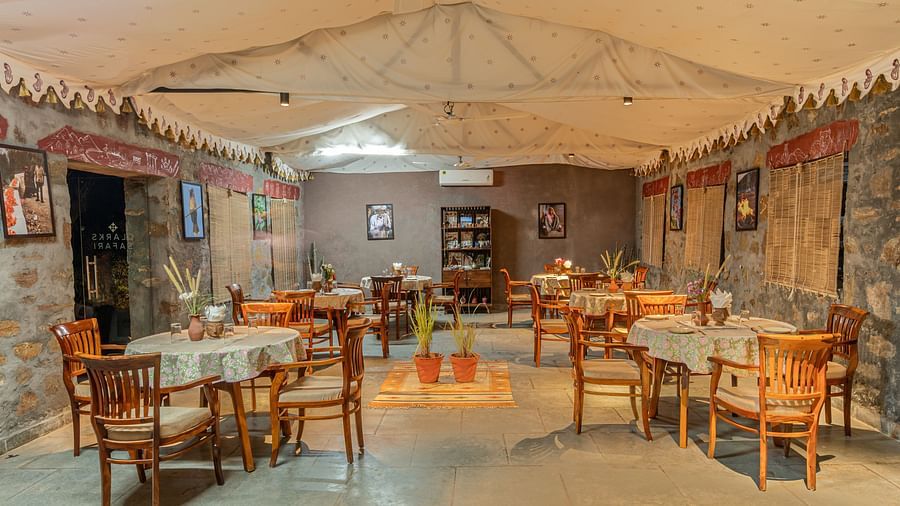 Rustic dining area with tribal-inspired decor and wooden furniture at Clarks Safari, Jawai.