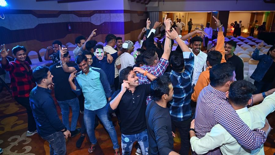 A group of people dancing inside a hall