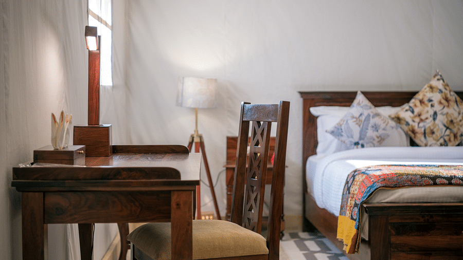A work desk and chair rests near the bed - Karwaan Jaisalmer