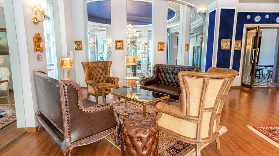 Four vintage chairs placed around a coffee table in the club house - The Manor Luxury Hotel, Shimla