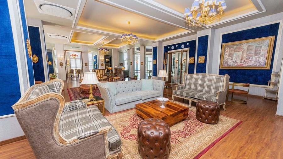 A view of the club house with comfortable furniture for people to sit and relax on - The Manor Luxury Hotel, Shimla