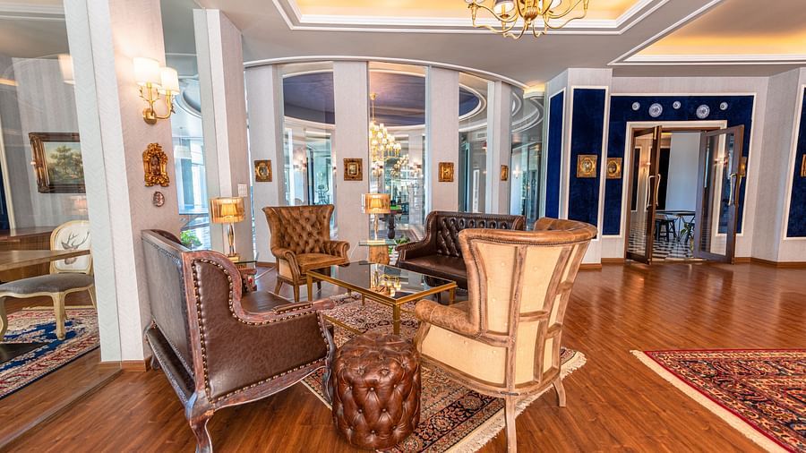 Another view of four vintage chairs placed around a coffee table in the club house - The Manor Luxury Hotel, Shimla