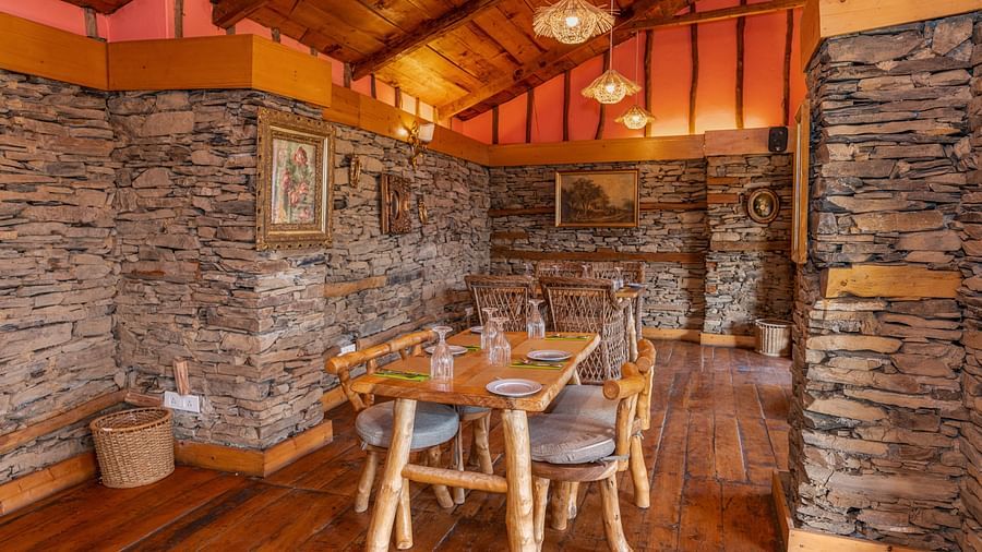 A view of the restaurant with furniture for seating, illuminated by ambient lighting - The Manor Luxury Hotel, Shimla