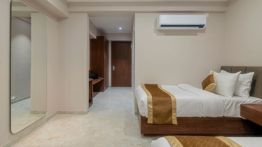 A double and a single bed inside the Super deluxe room - VITS Satyajeet Karad