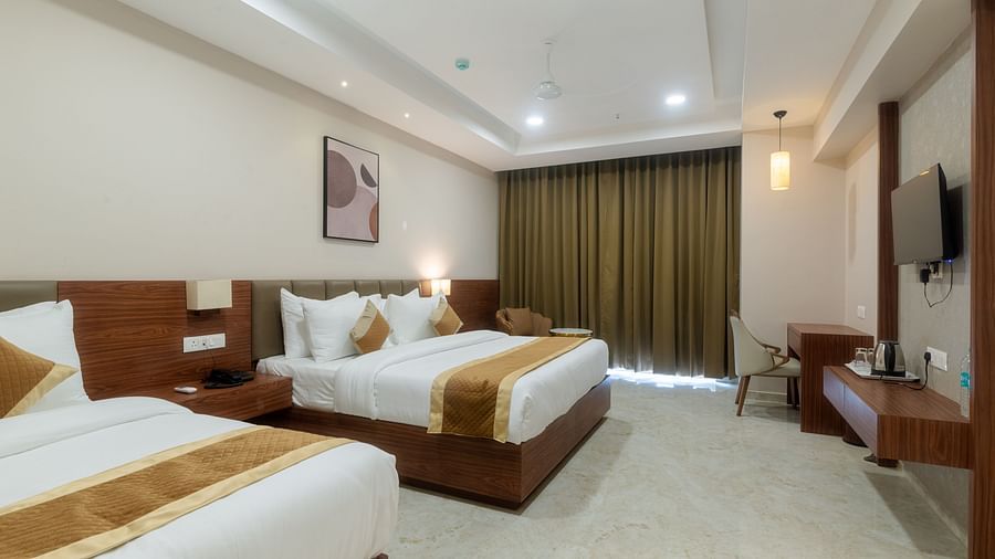 A double and a single bed inside the Super deluxe room - VITS Satyajeet Karad