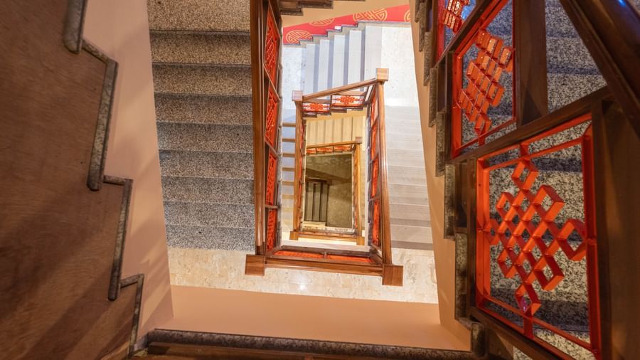 A top-down view of a staircase spiraling downward at Avianna Hungry Jack, Gangtok.