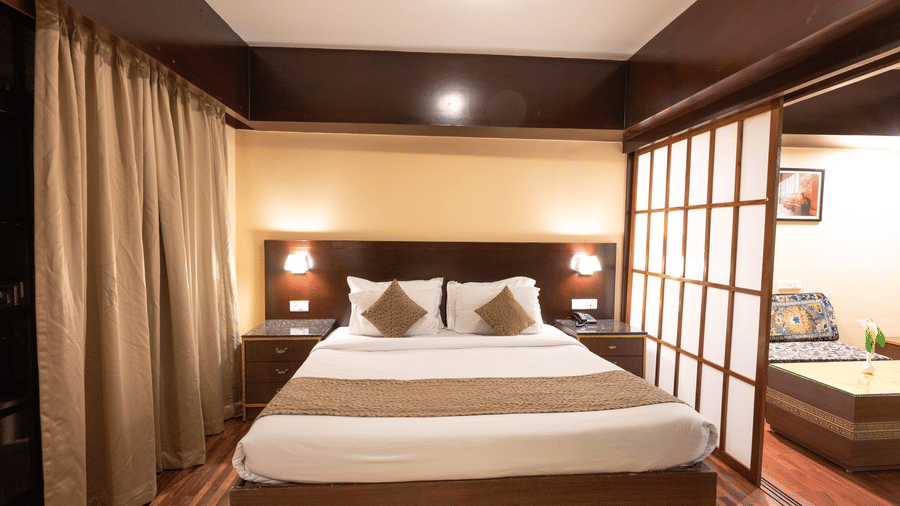 A bedroom with soft, illuminating lights at Avianna Hungry Jack, Gangtok.