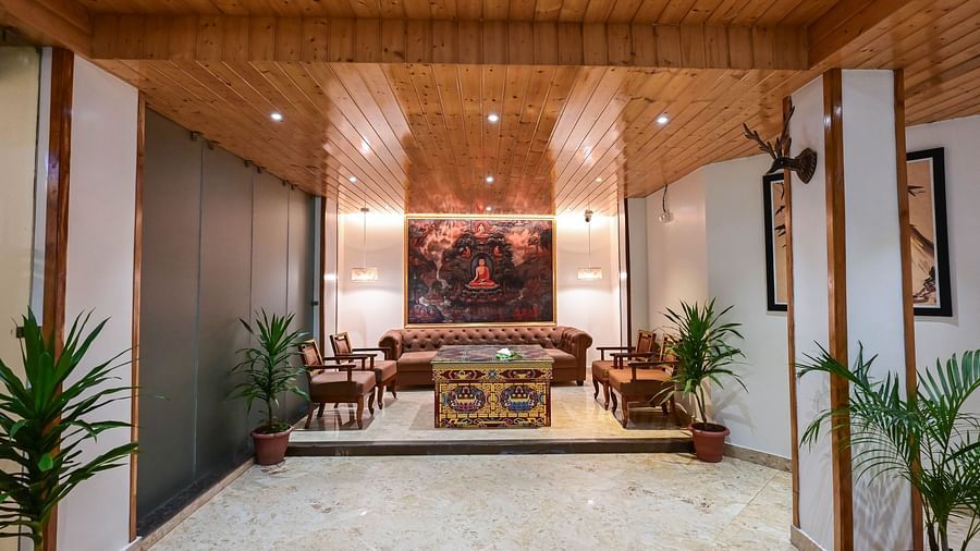 A reception area with wood accents, comfortable seating, and decorative artwork at Avianna Hungry Jack, Gangtok.
