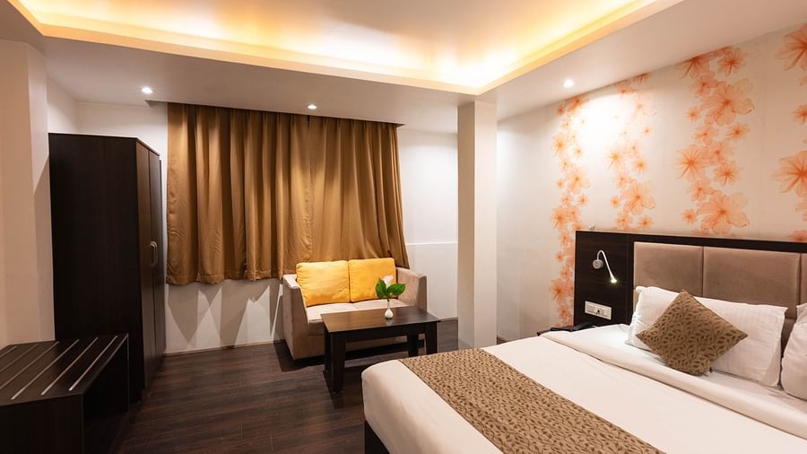 A bedroom with a window covered by curtains and a wardrobe at Avianna Hungry Jack, Gangtok.