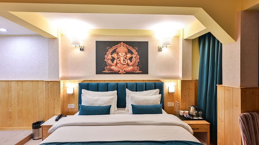 Deluxe Room with spacious bed, wooden furniture and warm lighitng at Avianna Seven Seas, Darjeeling10
