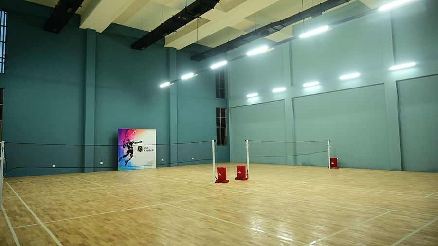 image of an indoor badminton court with ample space at club charholi, pune