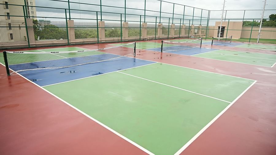 a close up image of one of the tennis courts at club chrholi, pune