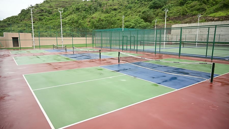 image of the tennis courts at club chraholi with a lowered net separating the two sides of the court
