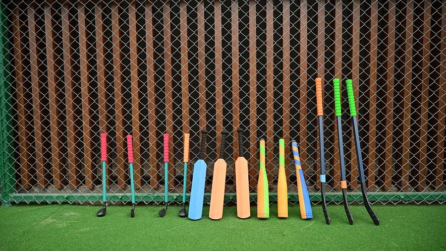various sports equipment for kids stood up against the wall at club charholi, pune