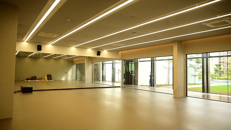 image of a spacious dance studio with hugh glass windows at club charholi, pune