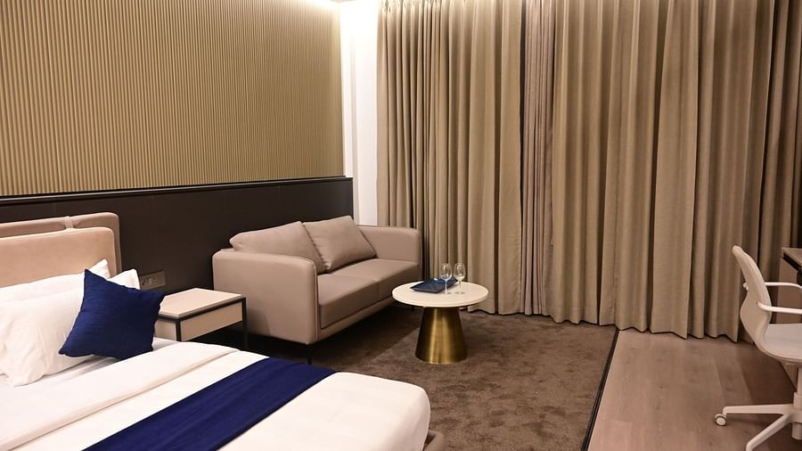image of the imperial guest suite at club charholi with a double bed and a seating area in the corner