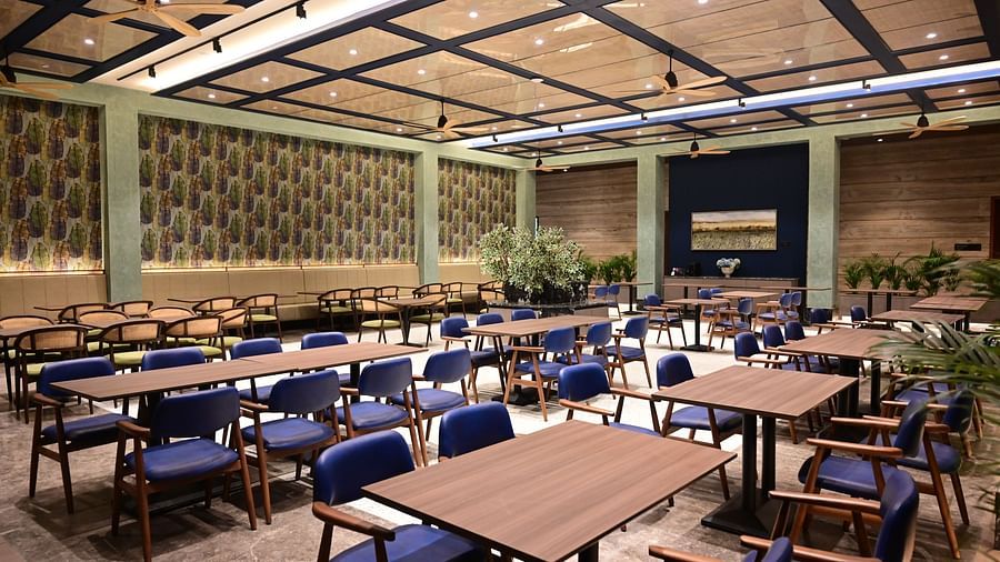 image of the well arranged dining area with huge ceiling lights at club charholi, pune
