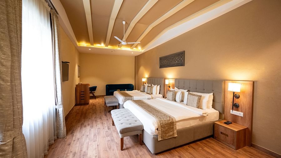 Studio quad bed room at Essentia Luxury Resort & Spa, Udaipur with modern interiors and a window with good lighting.