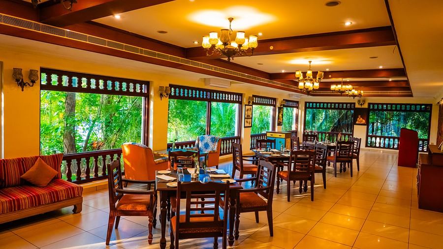 Restaurant dining area with a view of the lush surroundings.