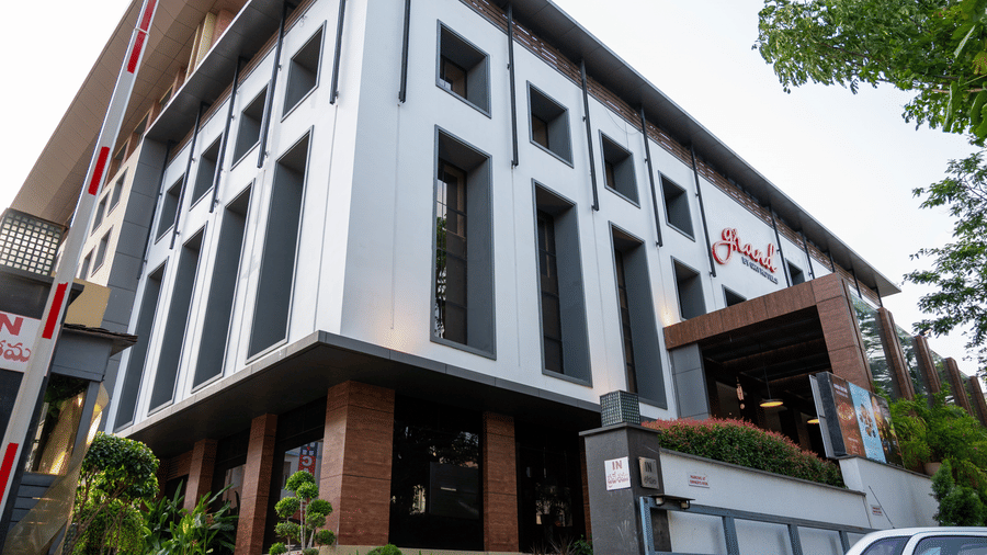 facade image of the Grand Kakinada by GRT Hotels surrounded by plants