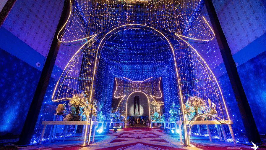 Brightly illuminated stage or entrance archway with elaborate blue and gold lighting and a sparkling curtain effect at Hotel Hukam's Lalit Mahal.