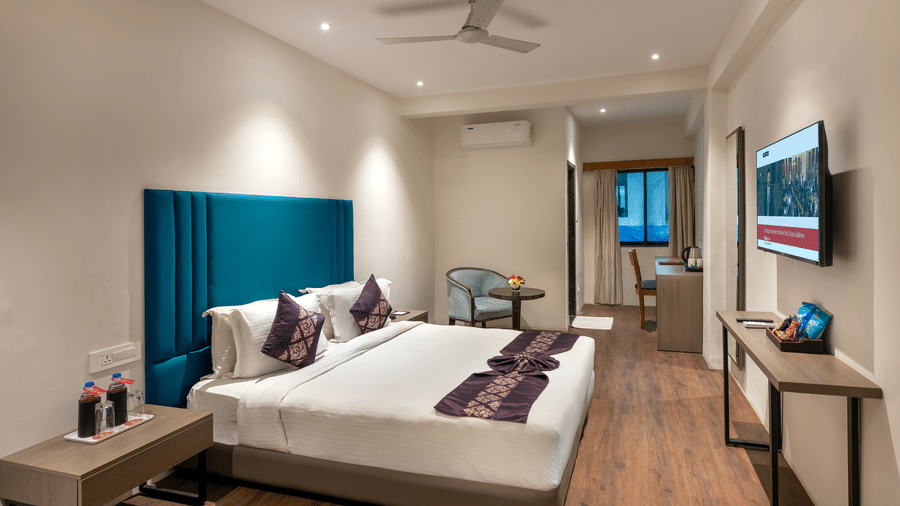  Lords Eco Inn bedroom featuring a large,  bed with a headboard, a ceiling fan, and modern furnishings.