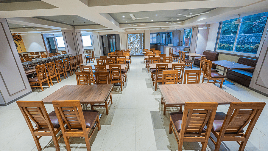 A bright dining area with neatly arranged wooden tables and chairs at Lotus Leaf Boutique Hotel.
