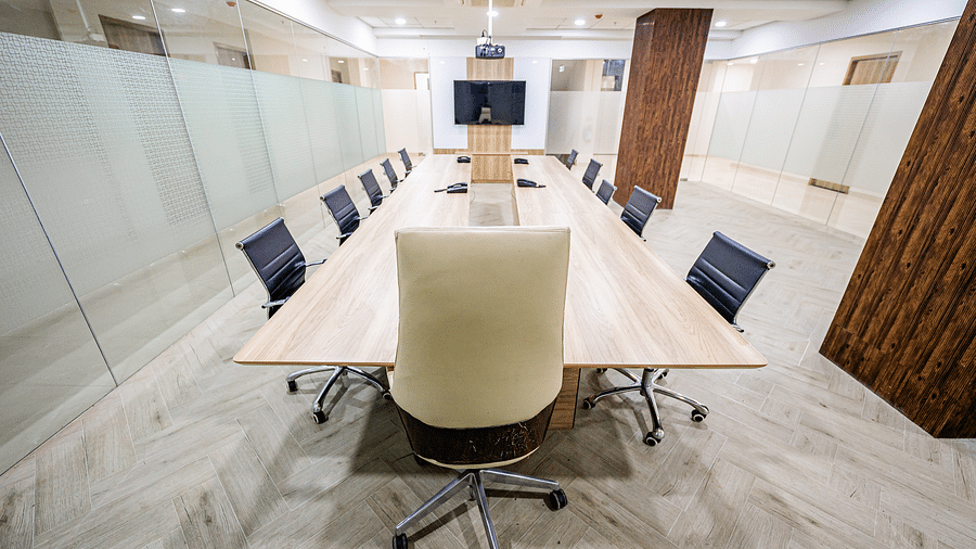 A well-equipped meeting room with a wooden conference table and office chairs at Lotus Leaf Boutique Hotel.